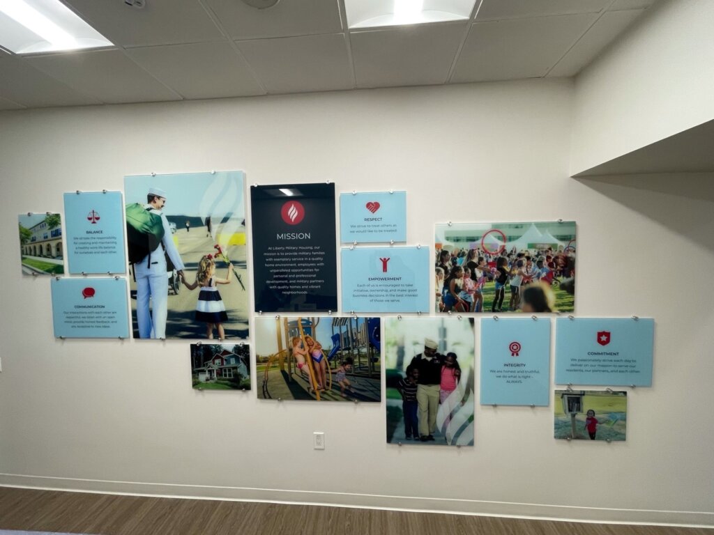 Photo highlights glass mosaic informational wall at nonprofit office