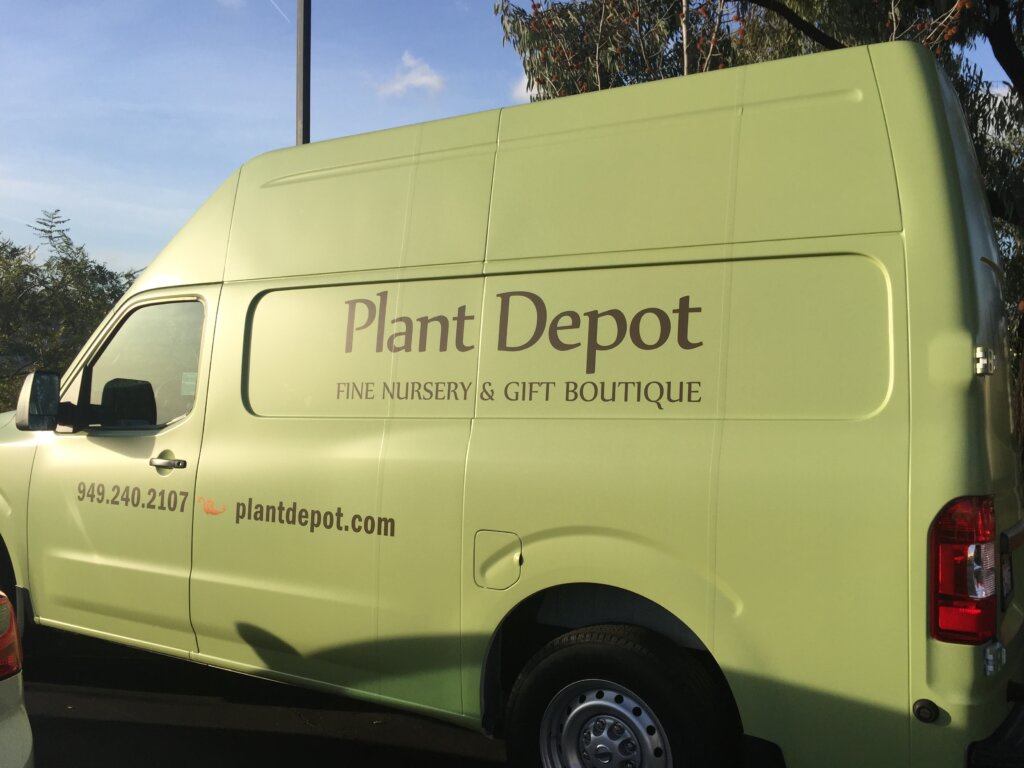 Photo of a green van, which reads "Plant Depot: Fine Nursery & Gift Boutique"